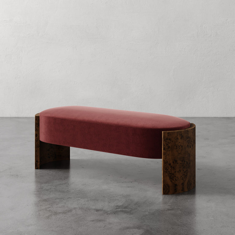 Lemieux et Cie Benoit Custom Upholstered Bench in blush velvet with curved Maple burl legs, shown on polished concrete floor against white walls.