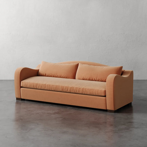 Lemieux Et Cie Elodie Sofa - Bench Seat (Made-to-order) Orange sofa against a plain wall on a gray floor