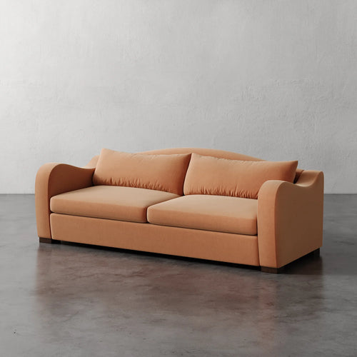 Lemieux Et Cie Elodie Sofa (Made-to-order) Orange sofa on a gray floor with a white wall background