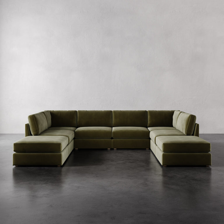 Lemieux Et Cie Chanaux Chanaux 8-Pc Sectional Green sectional sofa on a gray floor with a plain white wall background