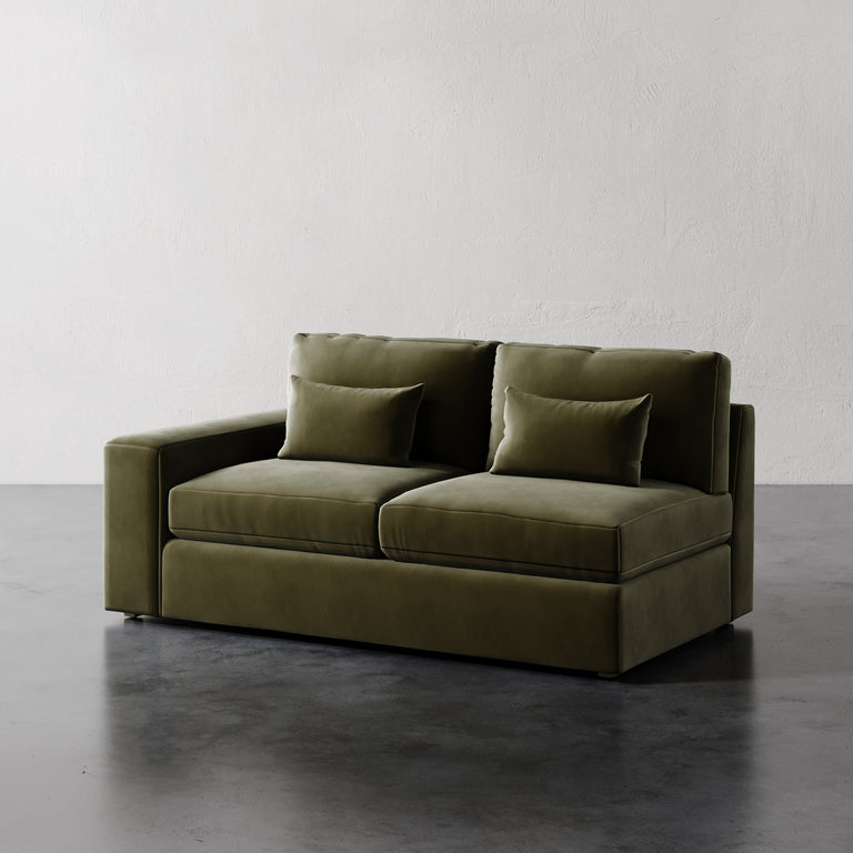 Lemieux Et Cie Lacroix Left or Right Arm Loveseat A dark green Lacroix left or right arm loveseat with two seat cushions and two bolster pillows, set against a neutral background.