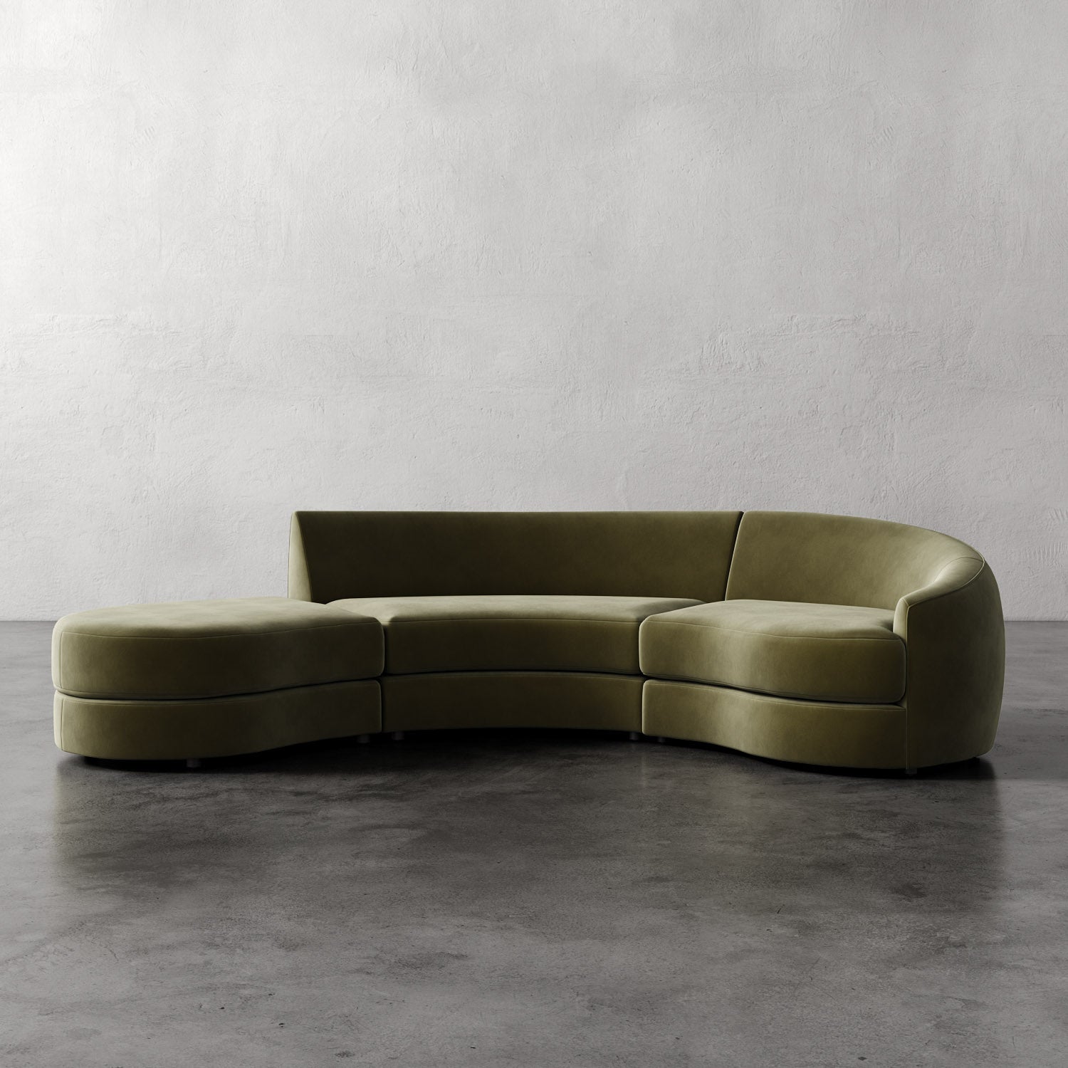 Lemieux Et Cie Rulmann 3-Piece Right Sectional Curved green sofa on a gray floor with a plain white wall background