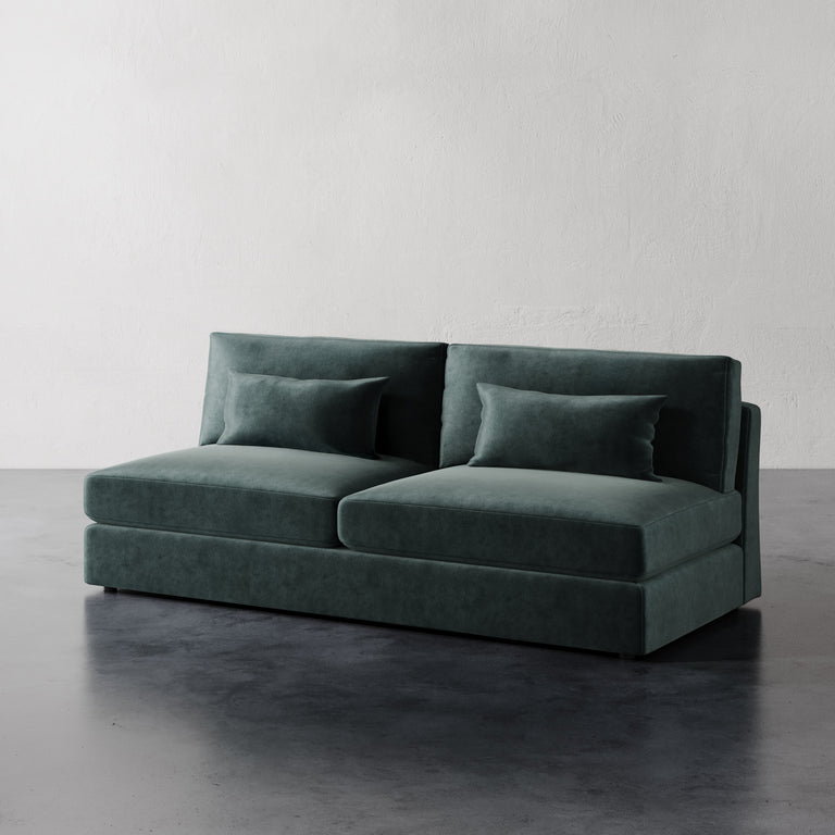 Lemieux Et Lacroix Armless Sofa A dark green armless sofa with two cushions, made with a minimalist design featuring clean rectilinear lines.