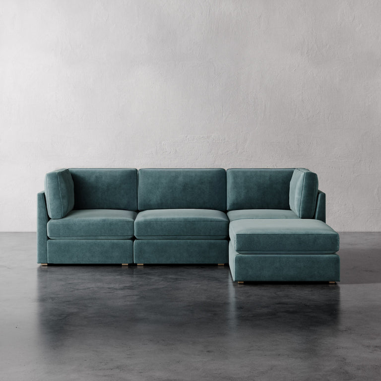 Lemieux Et Cie Chanaux 4-Pc Sectional Teal sectional sofa on a gray floor with a plain wall background