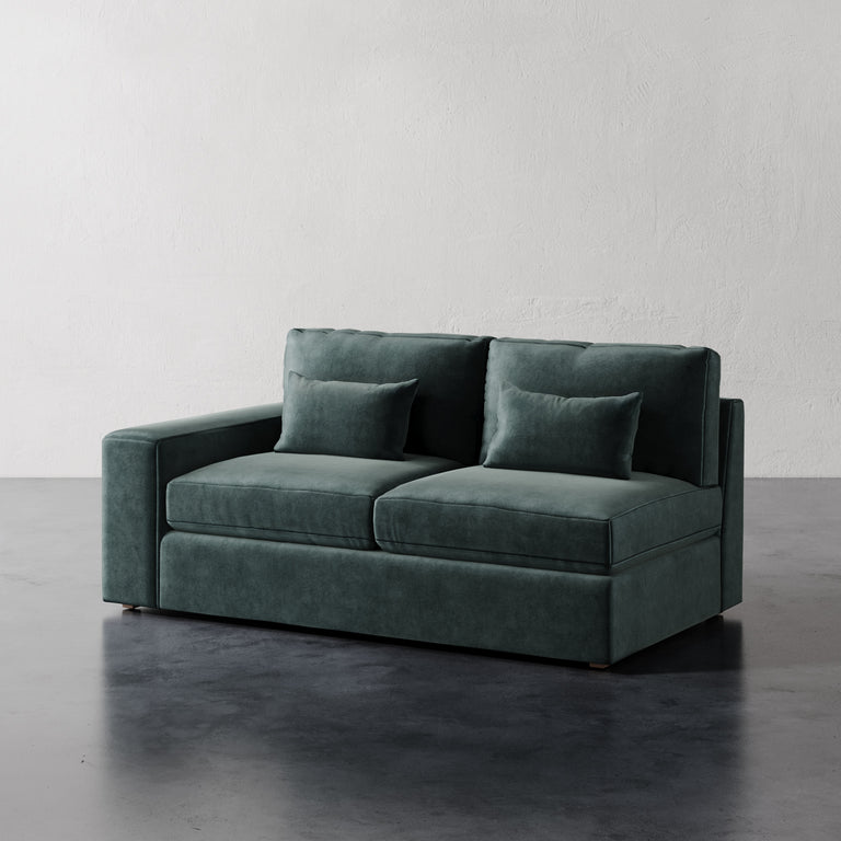 Lemieux Et Cie Lacroix Left or Right Arm Loveseat A dark green Lacroix left or right arm loveseat with two seat cushions and two bolster pillows, set against a neutral background.