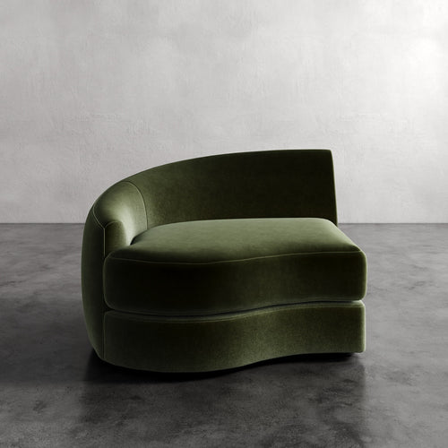 Lemieux Et Cie Rulmann Left Arm Chair Green curved sofa against a plain wall