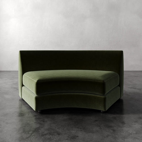 Lemieux Et Cie Rulmann Wedge Modern green sofa against a plain wall