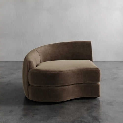 Lemieux Et Cie Rulmann Left Arm Chair Brown curved sofa against a gray wall