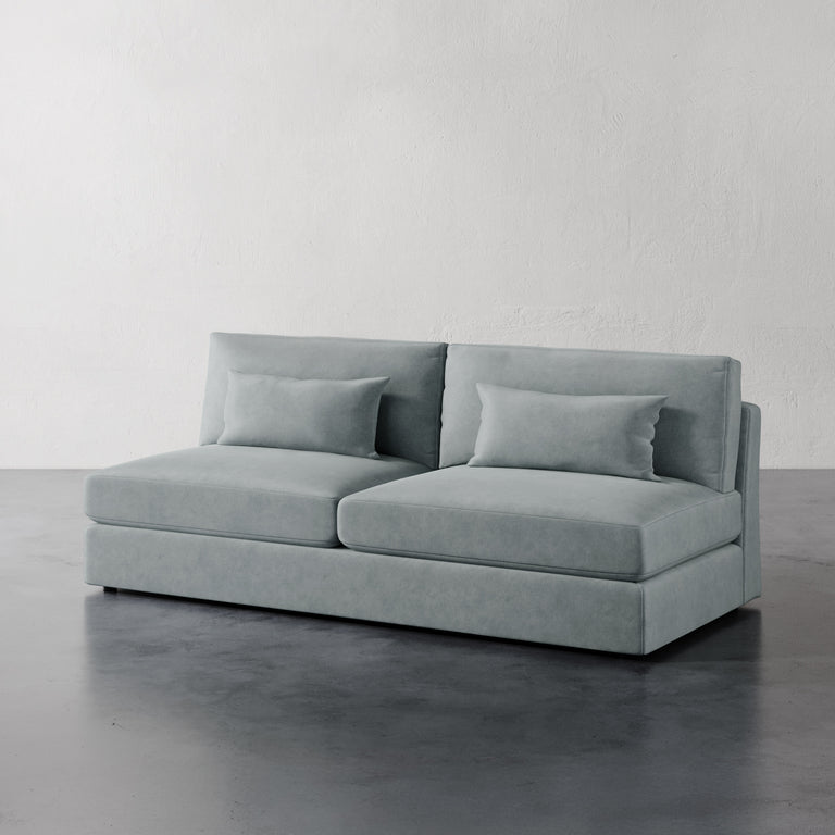Lemieux Et Cie Lacroix Armless Sofa A dark green armless sofa with two cushions, made with a minimalist design featuring clean rectilinear lines.