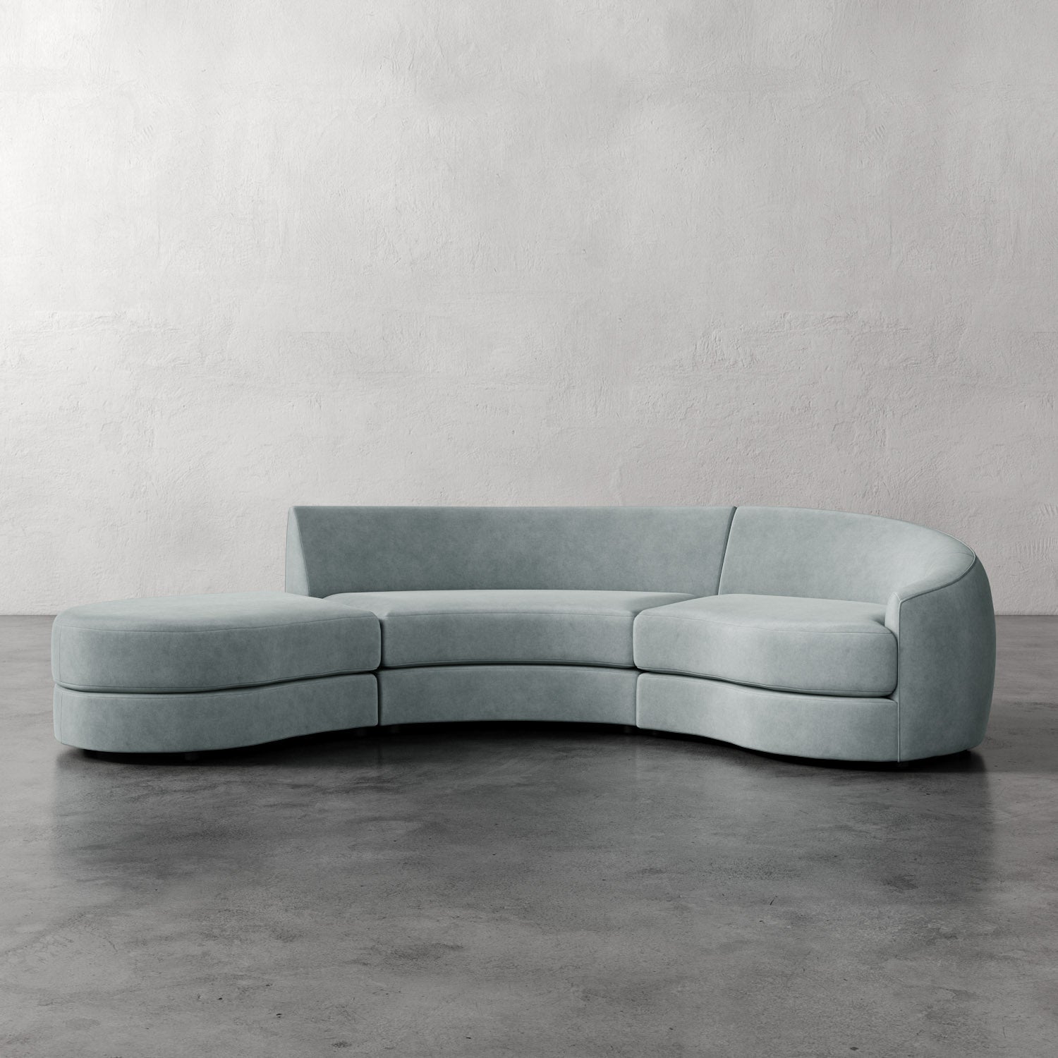 Lemieux Et Cie Rulmann 3-Piece Right Sectional Modern curved sofa in a minimalistic setting with a plain wall and concrete floor.