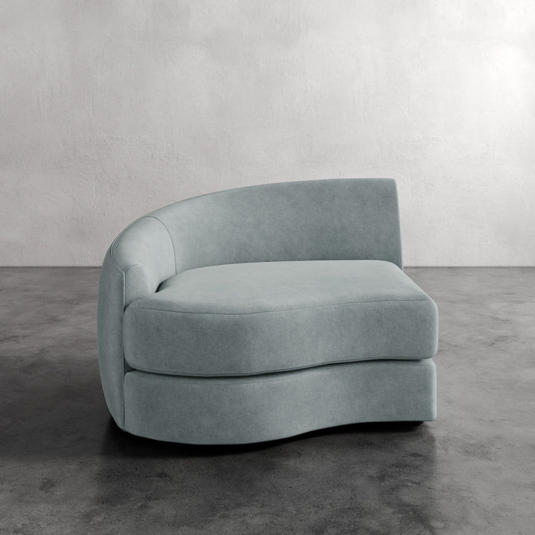 Lemieux Et Cie Rulmann Left Arm Chair Modern light blue sofa against a plain wall
