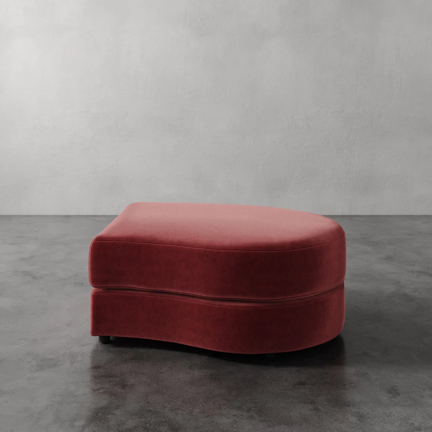 Lemieux Et Cie Rulmann Right Ottoman Red ottoman on a gray floor with a plain wall background