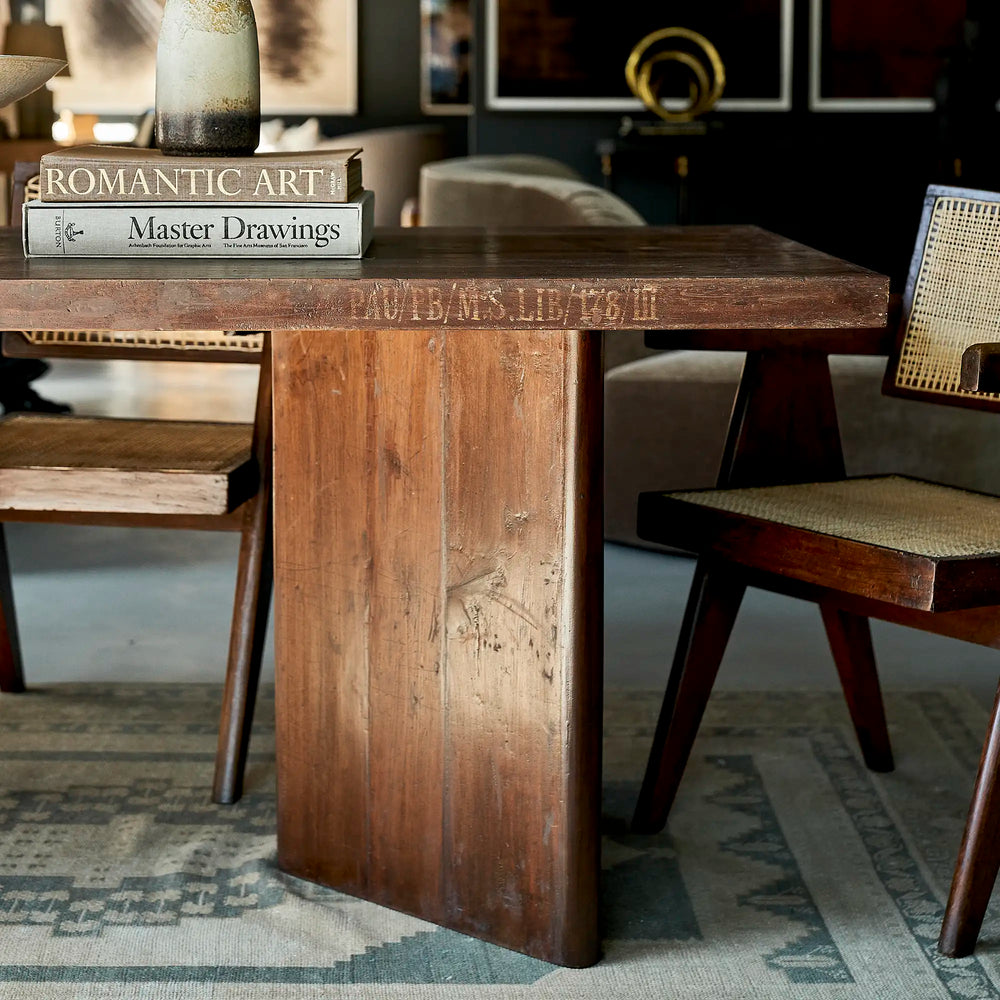 Lemieux et Cie Pierre Jeanneret library table in solid teak - panel-leg end styled with books against a gallery wall