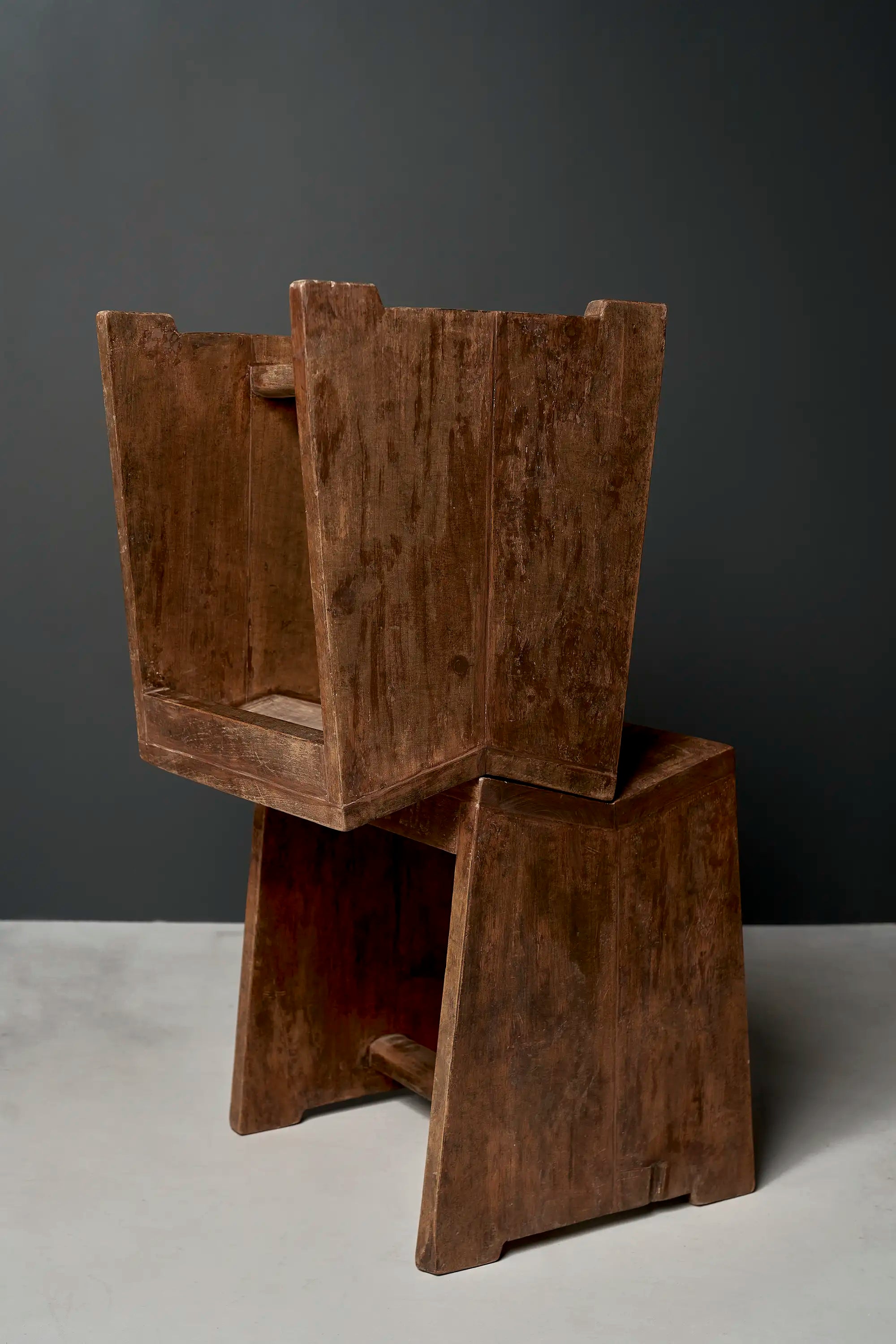 Lemieux et Cie Pierre Jeanneret stool in solid teak - two stools stacked at angles, showing the slab legs and saddle seats