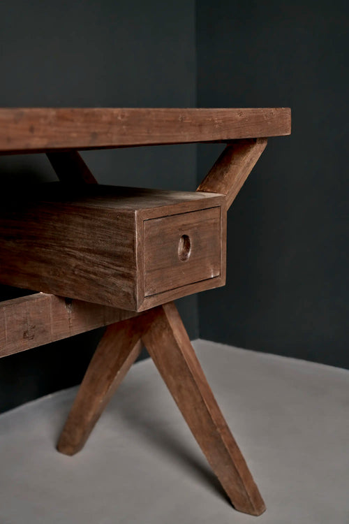 Lemieux et Cie Pierre Jeanneret writing desk in solid teak - three-quarter view showing the X-leg frames splaying to the floor and the drawer