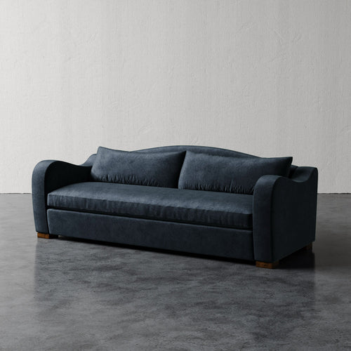Lemieux Et Cie Elodie Sofa - Bench Seat (Made-to-order) Blue sofa on a gray floor with a white wall background