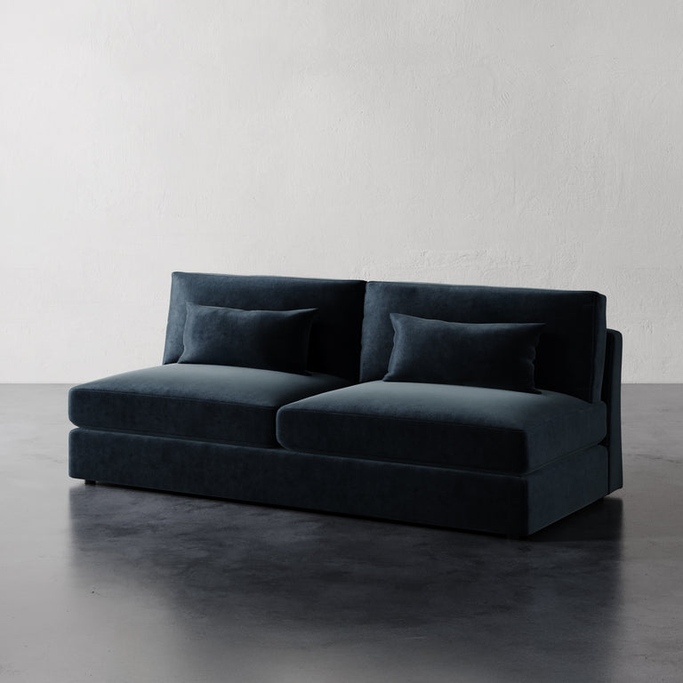 Lemieux Et Cie Lacroix Armless Sofa A dark green armless sofa with two cushions, made with a minimalist design featuring clean rectilinear lines.