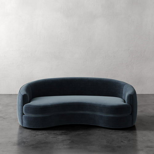 Lemieux Et Cie Rulmann Sofa Blue velvet sofa against a plain wall