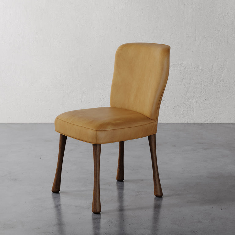 Rozette Dining / Side Chair (Leather) Tan on a gray floor with a white textured wall background