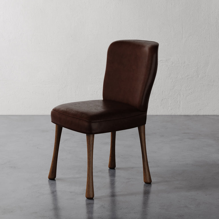 Rozette Dining / Side Chair (Leather) Brown leather chair on a gray floor with a white wall background