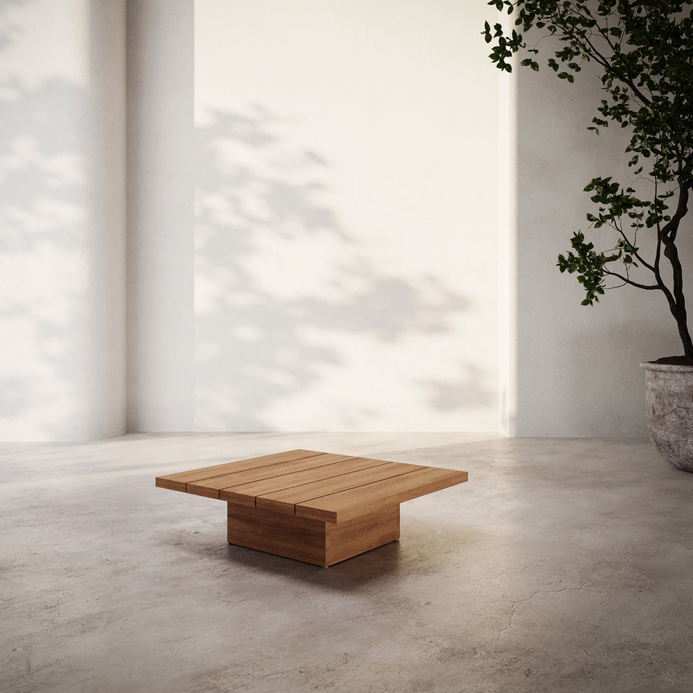 Lemieux et Cie S2 Teak Square Side Table in solid teak wood, outdoor side table on concrete floor in light-filled room with white walls