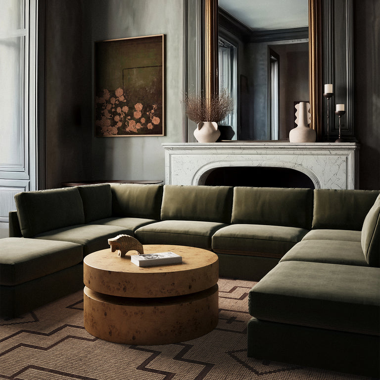 Lemieux Et Cie Chanaux 8-Pc Sectional
Modern living room with a green sectional sofa, round wooden coffee table, and decorative elements.