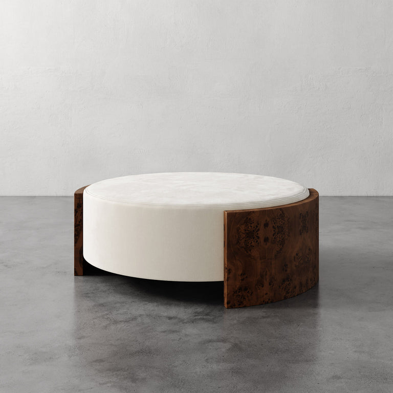Lemieux et Cie Benoit Coffee Table Ottoman in wire brushed oak and white marble, sculptural low-profile form on concrete floor in neutral studio setting.