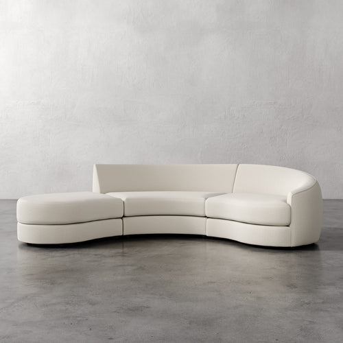 Lemieux Et Cie Rulmann 3-Piece Right Sectional Modern white curved sofa on a gray floor with a plain gray wall background