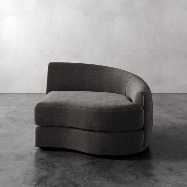 Lemieux Et Cie Rulmann Right Arm Chair Modern gray sofa against a plain wall on a concrete floor