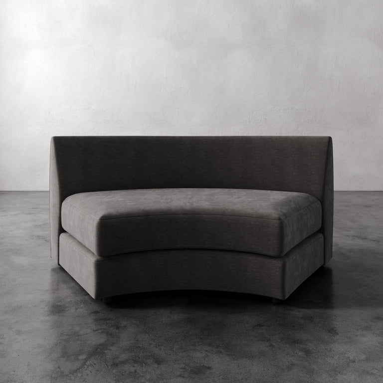 Lemieux Et Cie Rulmann Wedge Gray sofa against a plain wall