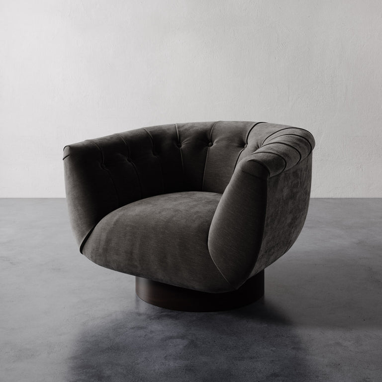 Strie mink grey Lemieux et Cie Lune Swivel Chair with a rounded tufted back and sculptural form set against a white wall.