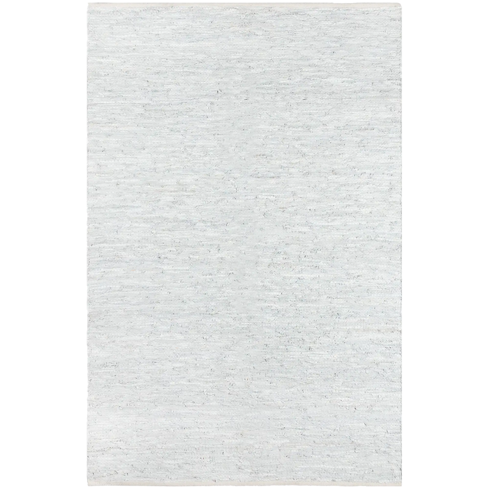Lemieux et Cie Tézah rug in pale grey handwoven recycled leather, shown on white studio backdrop.