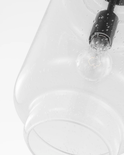 Lemieux et Cie Nodier Pendant detail, water droplets on curved glass form with dark trim, shown on white studio backdrop.