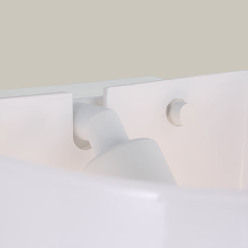 Lemieux et Cie Cheverny lighting collection in white plaster, sculptural sconce with organic curves and circular detail, shown against neutral wall