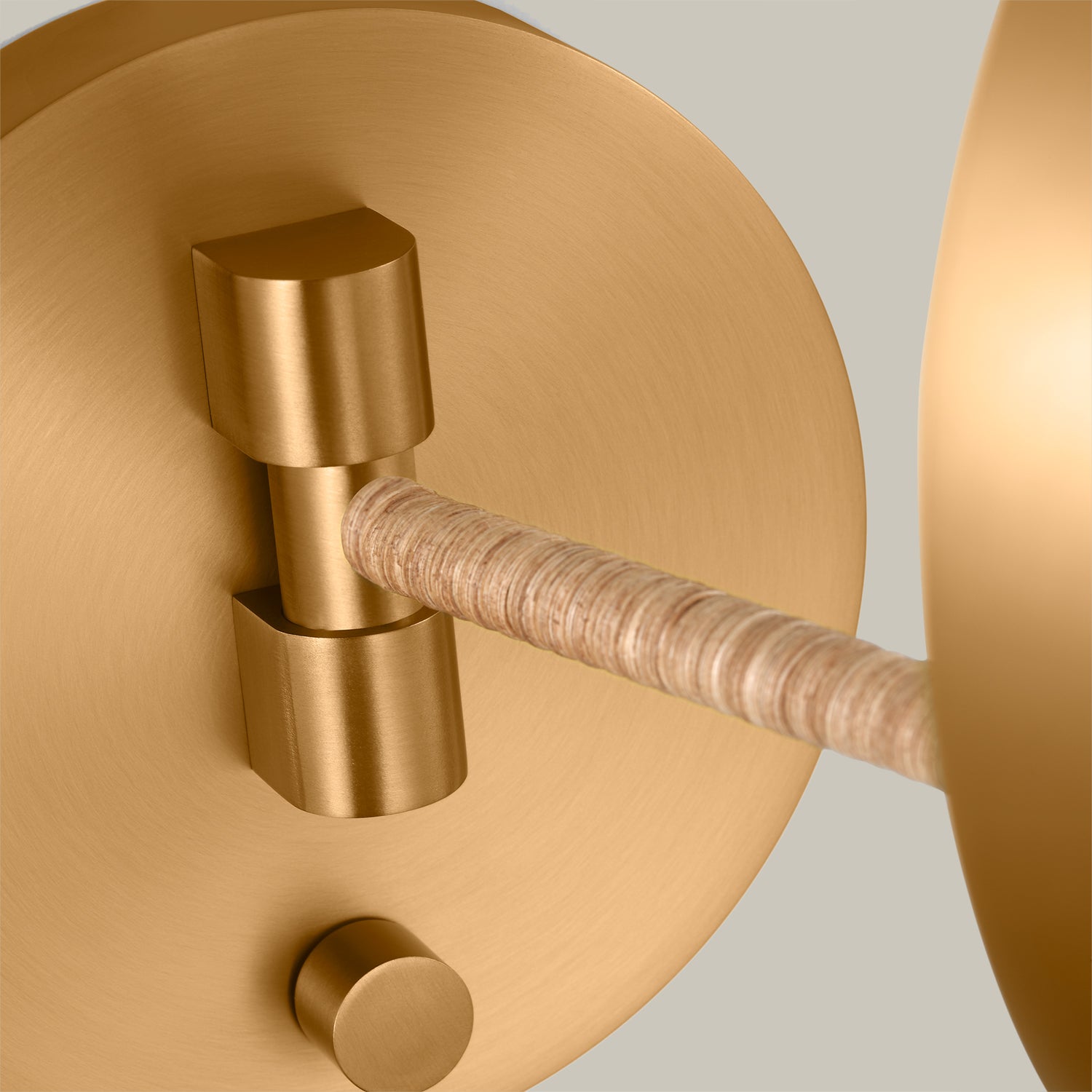 Lemieux et Cie Balleroy Medium Sconce, a designer lighting fixture close-up showing the round brass wall plate and the support arm from the back.