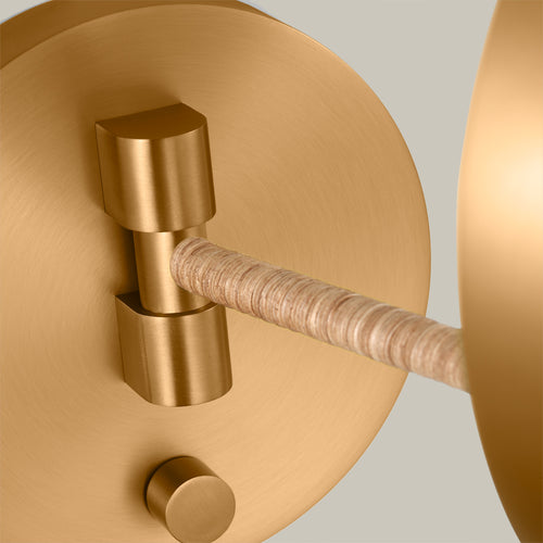 Lemieux et Cie Balleroy Medium Sconce, a designer lighting fixture close-up showing the round brass wall plate and the support arm from the back.
