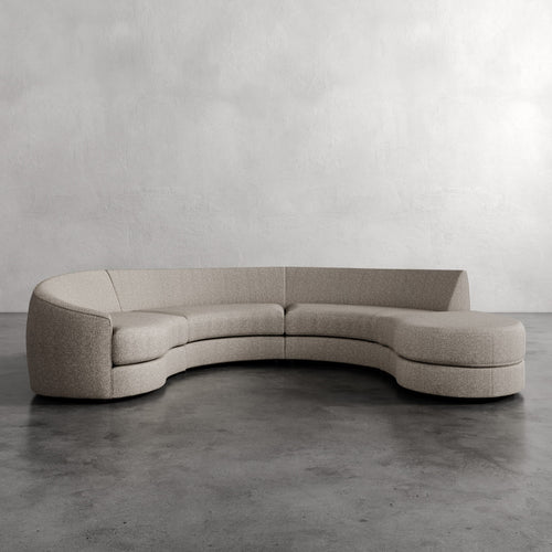 Lemieux Et Cie Rulmann 4-Piece Left Sectional Curved beige sofa against a plain wall