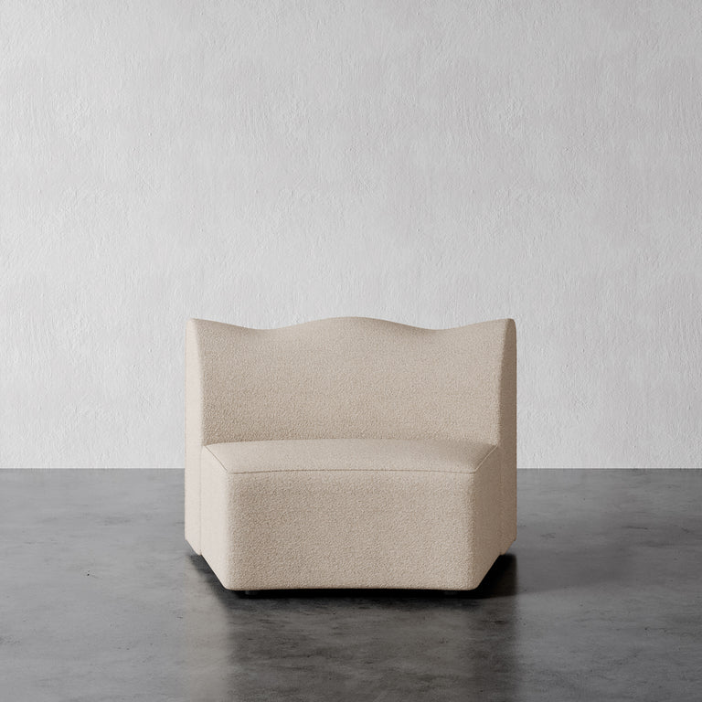 Lemieux Et Cie Wedge vista Beige armchair on a gray floor with a white wall background