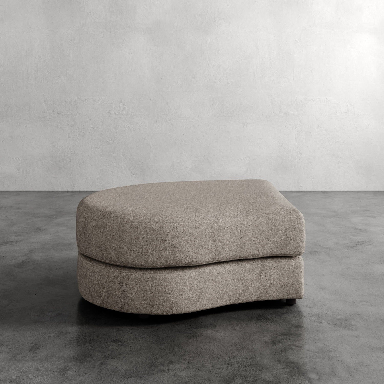 Lemieux Et Cie Rulmann Left Ottoman Gray ottoman on a concrete floor with a plain wall background