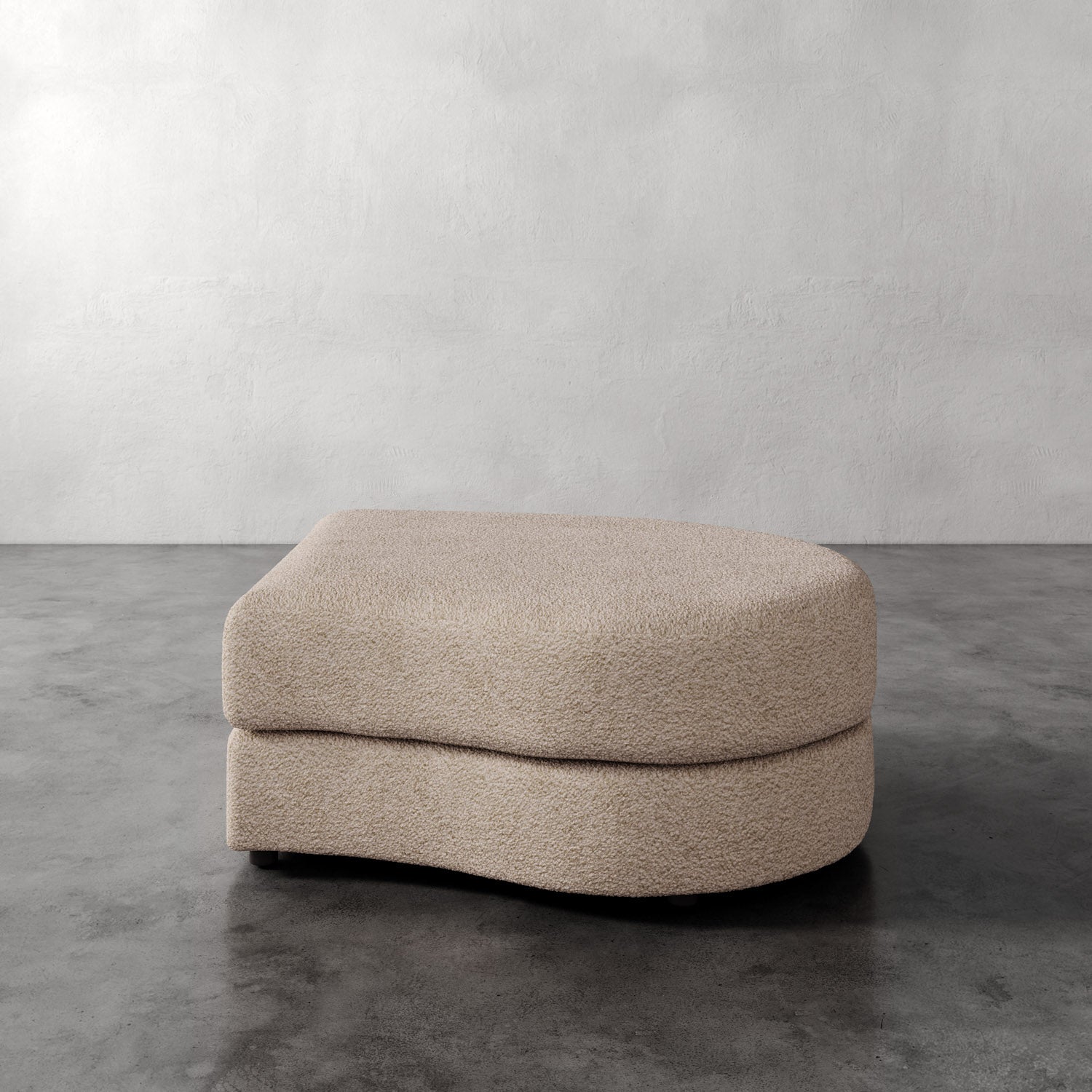 Lemieux Et Cie Rulmann Right Ottoman Beige ottoman on a gray floor with a white wall background