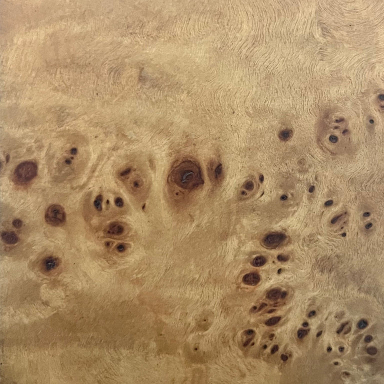 Lemieux et Cie Burl Wood Finishes swatch in warm honey tones with organic figured grain and dark knots, material sample shown on neutral surface.