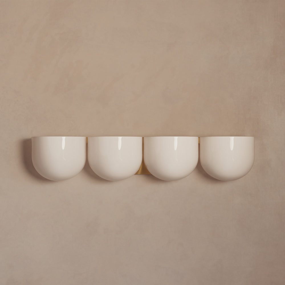 Lemieux et Cie Cocoon Lamp in resin with rounded diffuser form, set of four pendant lights shown against warm neutral walls in soft light.