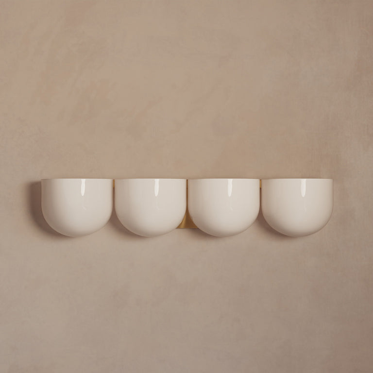 Lemieux et Cie Cocoon Lamp in resin with rounded diffuser form, set of four pendant lights shown against warm neutral walls in soft light.