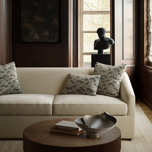 Linen decorative pillow cover with Japanese floral block print in deep indigo and sage on ecru ground, on the Arvelle sleeper sofa by lemieux et cie
