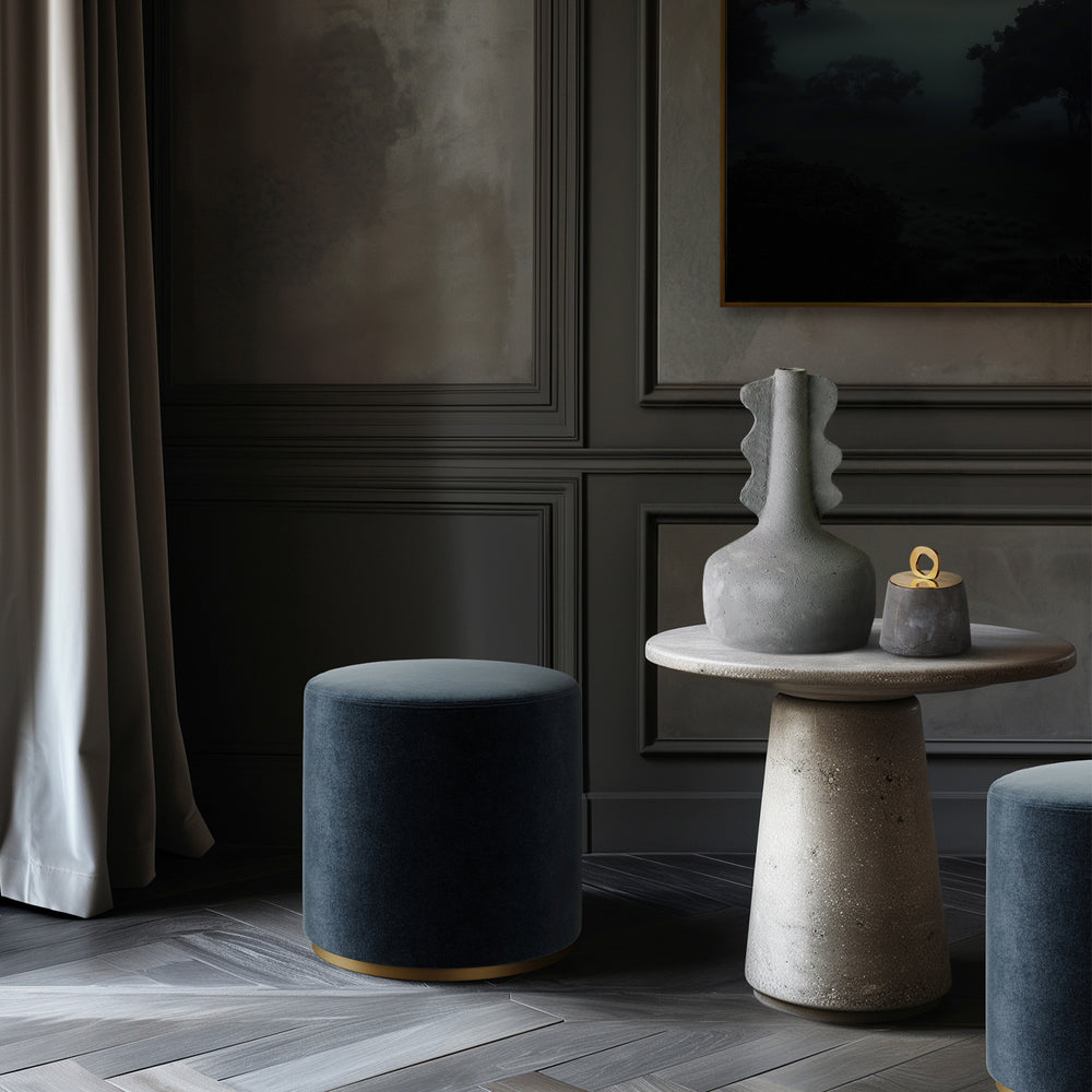 Lemieux et Cie Anouar Vase Collection in grey, sculptural form with organic ridged neck, styled on stone-top table in sitting room with dark paneled walls and wood floors.