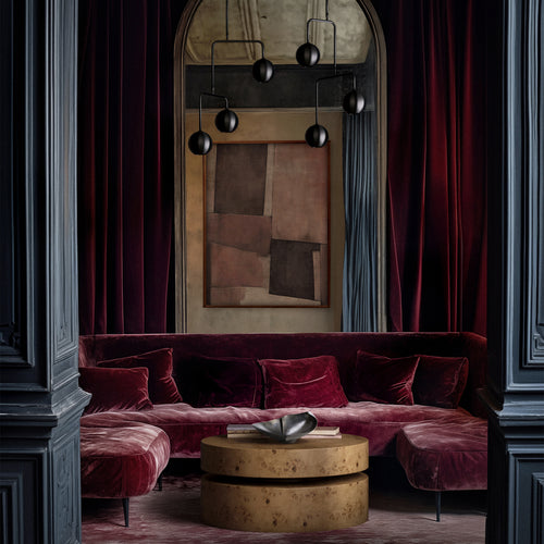 Lemieux et Cie Le Havre Limited Edition Art Print in cinnamon, blush and taupe, geometric abstract artwork shown above deep burgundy velvet sectional in room with paneled walls and arched mirror.