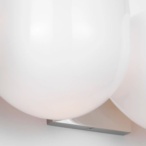 Lemieux et Cie Cocoon Lamp with sprayed resin diffuser and angled metal bracket, sconce mounted on white wall in soft daylight.