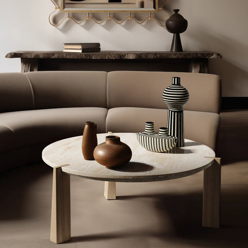 Lemieux et Cie ceramic vases with hand-painted black and white striped patterns, displayed on a marble coffee table in a neutral sitting room with taupe sofa.