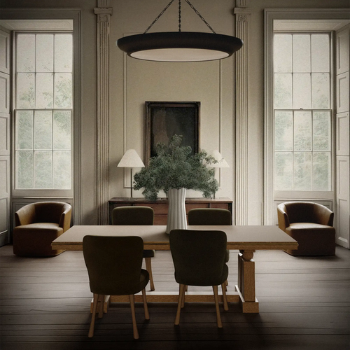 Lemieux et Cie Corvaux Dining Table in a neutral dining room with tall windows, wood floors, upholstered chairs, dark pendant chandelier, and classical architectural detailing.