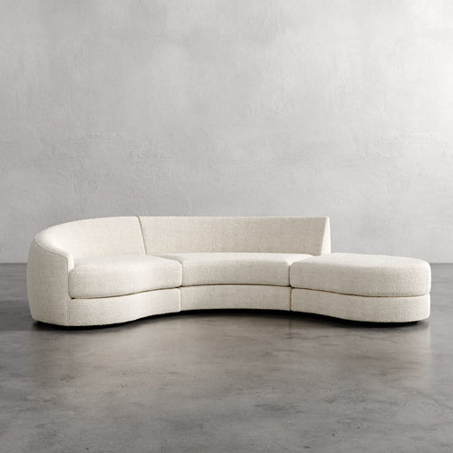 Curved beige sofa against a plain wall Rulmann 3-Piece Left Sectional Cream Berber